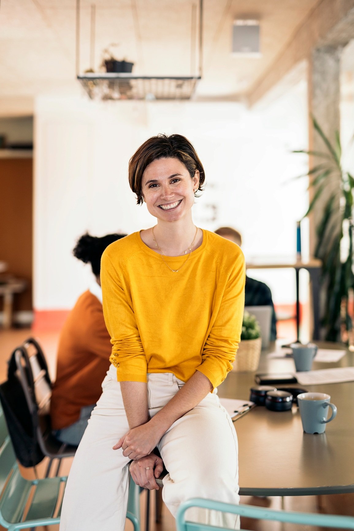 Lady at a meeting table in a yellow top