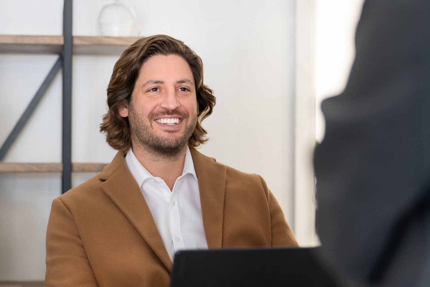 Anthony Sallis smiling in a meeting