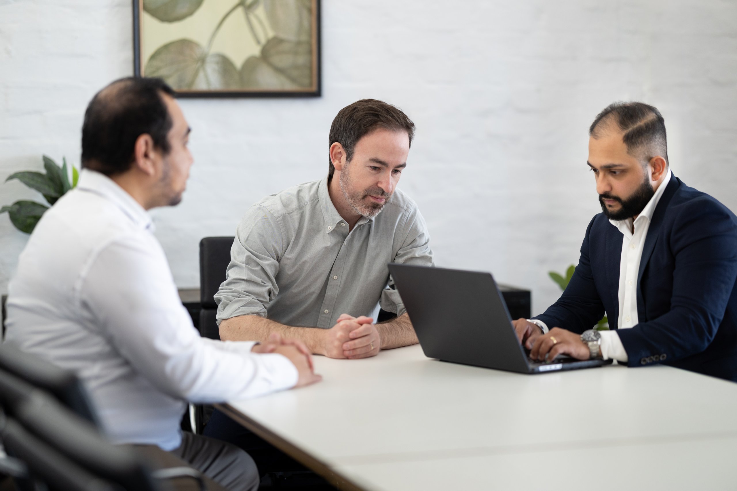 Aaron Gary, Manraj Singh, and Ian Pelayo having a meeting